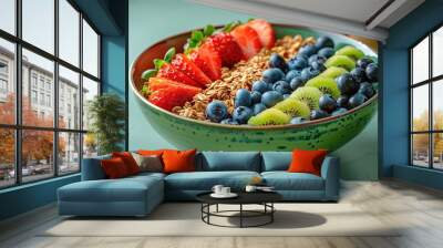 A vibrant green bowl filled with colorful fruits and granola, set against an isolated bright green background Wall mural