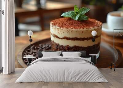 Close-up of a tiramisu dessert with a mint garnish on a wooden tray. Wall mural