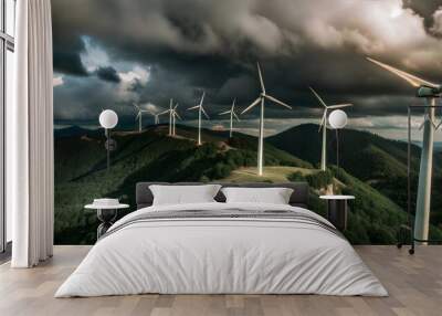 Wind turbines on a green hill under dramatic sky Wall mural