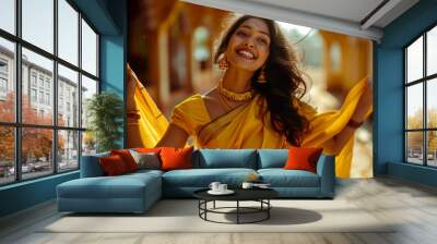 A female in a golden yellow saree, dancing Wall mural