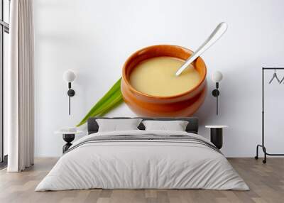 Pure cow ghee in ceramic bowl with steel spoon on white background Wall mural