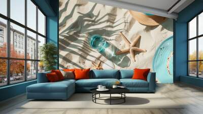 Flat lay image of  beach themed items, fedora, starfish, sand, and water. Wall mural