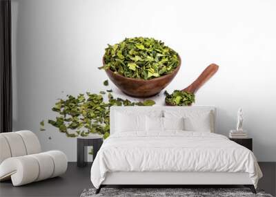 Dry neem leaves or azadirachta indica in wooden bowl on white background with wooden spoon Wall mural