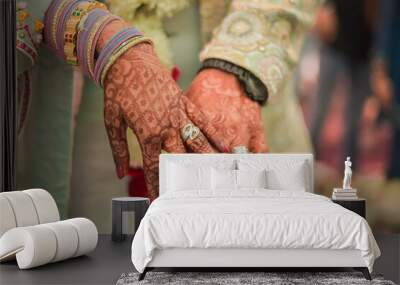 Indian groom and bride hand in hand showing ring Wall mural