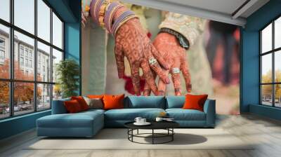 Indian groom and bride hand in hand showing ring Wall mural