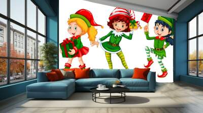 Three girls dressed in elf costume for Christmas Wall mural