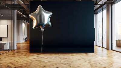 A silver star-shaped balloon floating on an isolated black background, shimmering under soft light. Wall mural