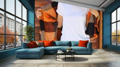 Women wearing blank white tshirt with copy space for your text or design. White t-shirt mock up with orange - black shawl Wall mural