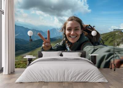 Woman hiking in the mountain selfie with smartphone Wall mural