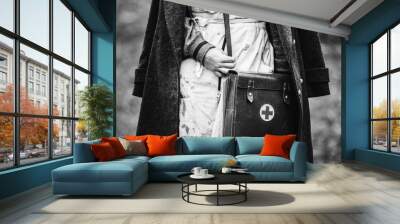 Re-enactor Wears Historical German Nurse Paramedic Of World War II Uniform With First Aid Kit. Photo In Black And White Colors. WWII WW2 Wall mural