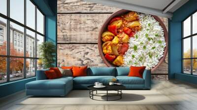 Chicken jalfrezi Indian spicy curry chilli meat with basmati rice and vegetables healthy dietetic asian food in clay dish on vintage table background. Wall mural