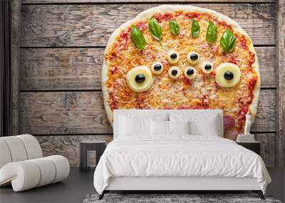 halloween creative scary food monster zombie face with eyes pizza snack with mozzarella, basil and s Wall mural