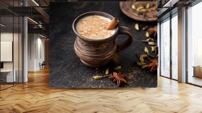 Masala pulled tea chai latte hot Indian sweet milk spiced drink, ginger, fresh spices and herbs blend, anise organic infusion healthy wellness beverage teatime ceremony in rustic clay cup Wall mural