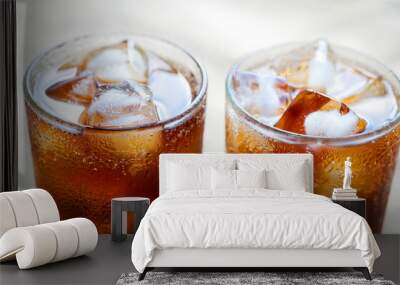 Two glasses of cola with ice. Close-up of a refreshing drink. Wall mural