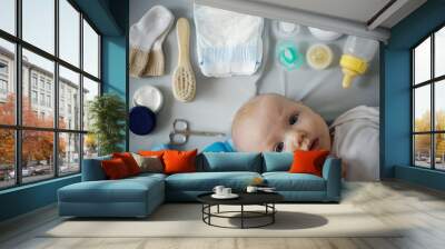 Baby on grey background with toiletries and health care accessories. maternal concept.overhead view Wall mural