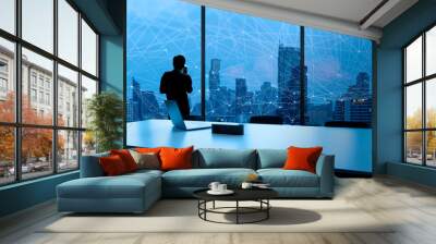 Businessman standing using smart phone and Business Wireless network in office desk and windows and Bangkok city view. Wall mural