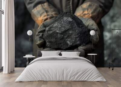 A coal miner presenting a large lump of coal with his soiled hands. Wall mural