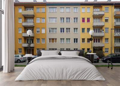 apartment building in the city of munich, Germany with two rows of three windows on each floor and one wall that is painted beige with yellow accents Wall mural