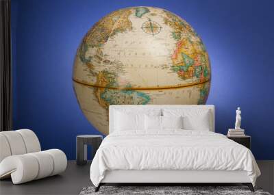 a globe of the earth against a blue background Wall mural