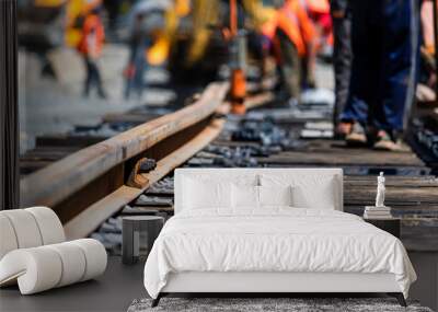 Workers in bright uniforms lay railway or tram tracks Wall mural