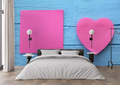 Blank pink paper note in two different shapes - square and heart shape on grunge blue wooden background with copy space Wall mural