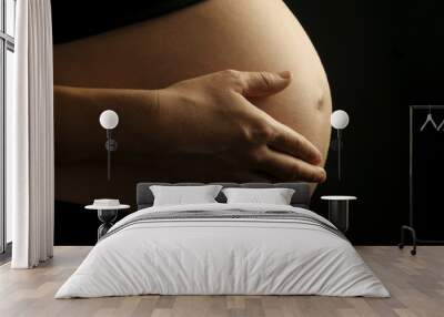 pregnant woman caressing stomach Wall mural