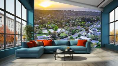 Sunset over houses on ocean coastline - aerial panorama Wall mural