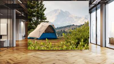 Tent against the background of forest and mountains. Wall mural