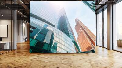 A beautiful view of the skyscrapers from the bottom up, against the background of the sky, glare from the sun Wall mural