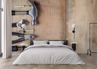 Hammer, wrench, screwdriver and pliers on a workbench, top view Wall mural