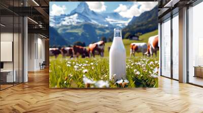 Glass bottle with milk on the grass and cow grazing in meadow on green meadow, flowers and mountains. Fresh organic milk. A herd of cows in field. Wall mural