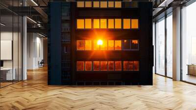 A high-rise apartment window, reflecting the golden hues of a setting sun. Wall mural