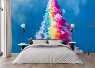 A jet flying in the sky releasing coloroful smokes in abstract pattern, the concept of unleashing creativity Wall mural