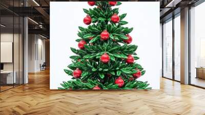 A vibrant green Christmas tree with bold red ornaments on a bright white background.  Wall mural