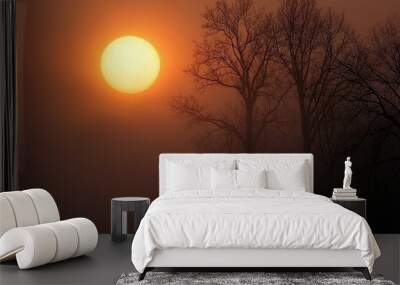 The rising sun as seen through dense fog, with trees appearing ghostly in the background.  Wall mural