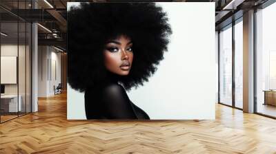 A beautiful Black woman with a large, voluminous afro hairstyle, posing for the camera. Wall mural