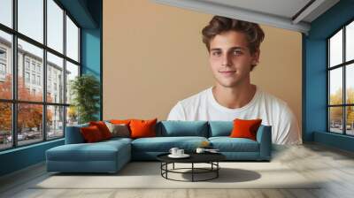 A handsome young man in white tshirt on neutral background. Wall mural