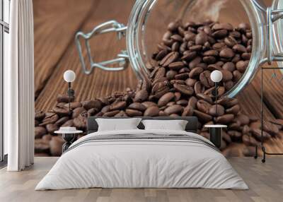 Glass jar with coffee beans on textured wooden table Wall mural