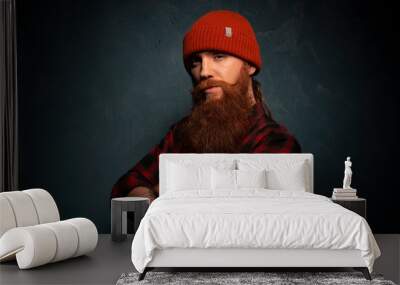 Red bearded man with orange hat and plaid shirt on cyan background Wall mural