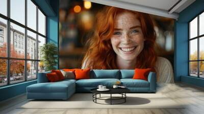 A happy young red haired girl with freckles looking and laughing. Wall mural