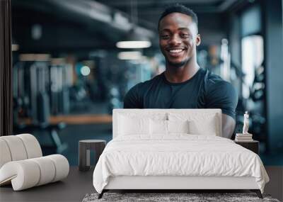 Handsome trainer at the gym. Wall mural