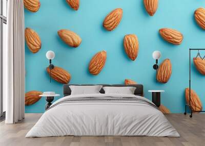 Many almond nuts on a blue background. Wall mural