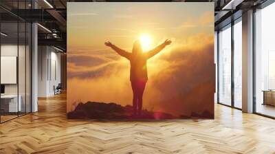 Silhouette of happy woman open arms in sunrise at mountain top Wall mural