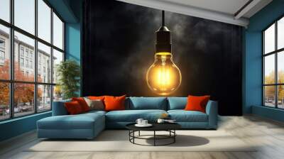 tungsten light bulb lit on black background Wall mural