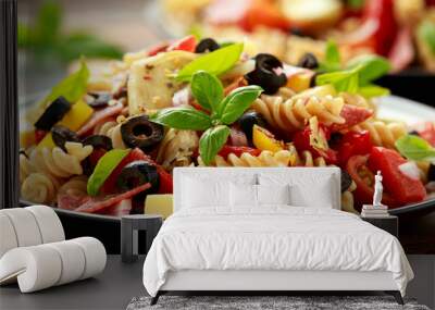 Antipasto salad with pasta, tomato, olives, red onion, bell pepper, salami, cheese, artichoke and basil. Wall mural