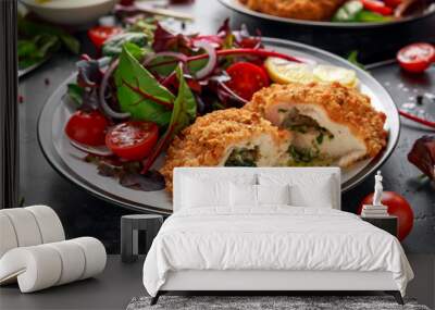 Breaded Chicken Kiev breast stuffed with butter, garlic and herbs served with vegetables in a plate. Wall mural