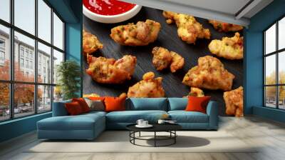 Chicken Pakora dish with sweet chilli sauce on rustic stone board Wall mural