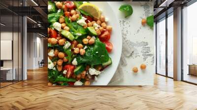 Chickpeas Salad with cucumber, tomatoes, feta cheese and green mix in a white plate. healthy food. Wall mural