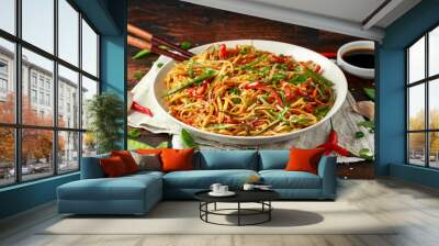 Chow mein, noodles and vegetables dish with wooden chopsticks Wall mural