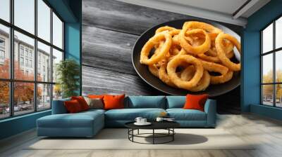 Crunchy Fried Battered onion rings on black plate Wall mural